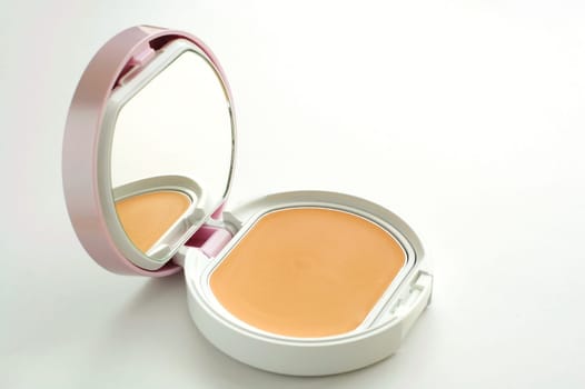 A vanity case of facepowder over white background