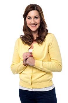 Relaxed woman standing with hands clasped