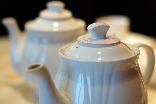 A close up view of two Chinese ceramic teapots