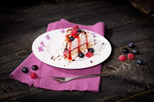 Raspberry cream cake with fresh raspberries and blueberries