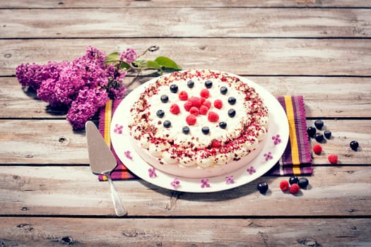 Raspberry cream cake with fresh raspberries and blueberries