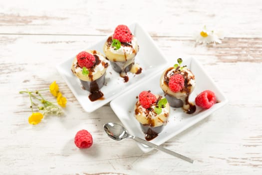 Chocolate cups with vanilla pudding,cream and raspberries