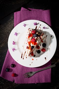 Raspberry cream cake with fresh raspberries and blueberries
