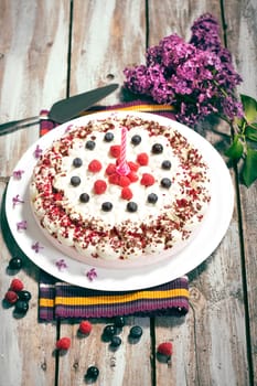 Raspberry cream cake with fresh raspberries and blueberries