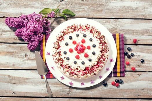 Raspberry cream cake with fresh raspberries and blueberries