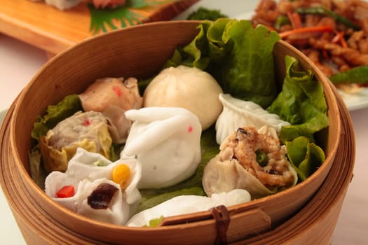 wontons in wooden bowl with sticks