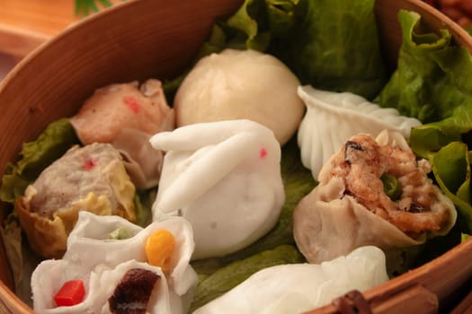 wontons in wooden bowl with sticks