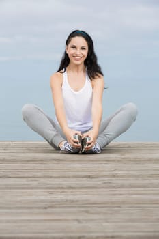Beautiful young woman in outdoor doing yoga