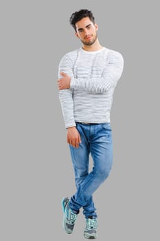 Portrait of happy handsome young man looking through his hands