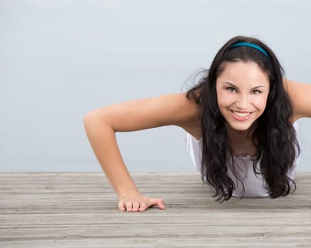 Beautiful young woman in outdoor doing yoga