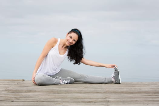 Beautiful young woman in outdoor doing yoga