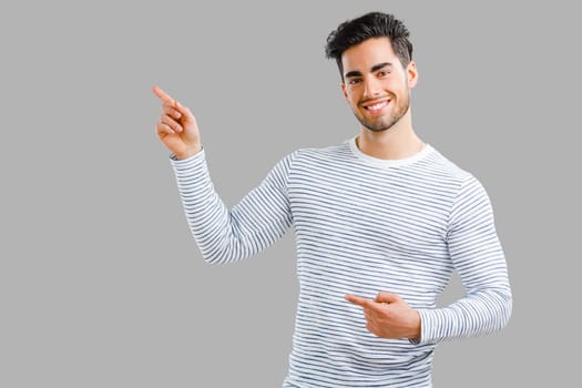 Happy and handsome young man talking at phone, isolated on white background