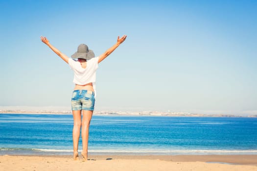 Beautiful young woman enjoying the beach