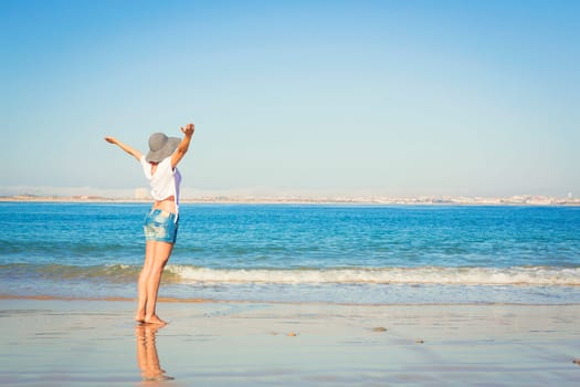 Beautiful young woman enjoying the beach