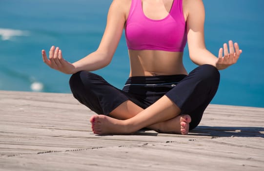 Beautiful young woman in outdoor doing yoga