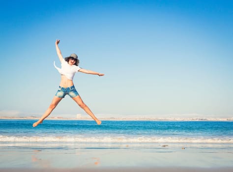 Beautiful young woman enjoying the beach