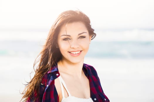 Portrtait of a happy girl at the beach enjoying the life