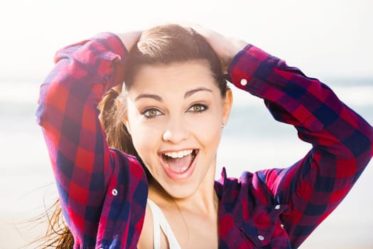 Portrtait of a happy girl at the beach enjoying the life