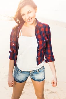 Portrtait of a happy girl at the beach enjoying the life