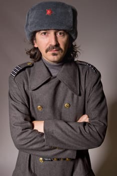young man dressed as russian military, studio picture