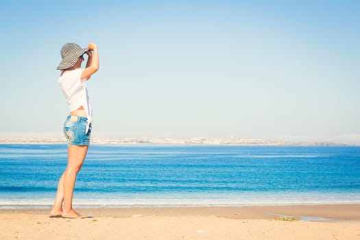 Beautiful young woman enjoying the beach