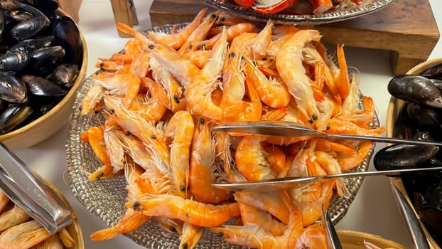 Shrimp and prawns in a bowl on a buffet.