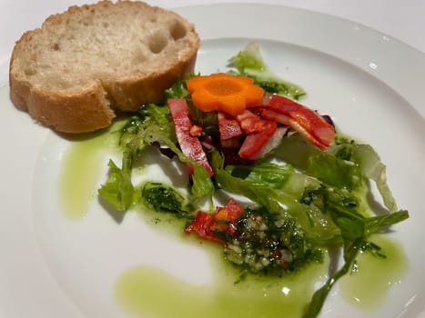 A salad plate with a wide variety of ingredients on a table.