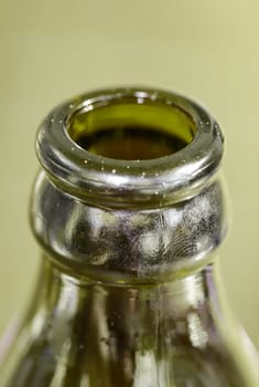 A close-up of a neck of a glass bottle for beverages.