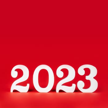 Happy New Year 2023. Bright red square banner with white wooden numbers 2023 stand at bottom. Merry Christmas. Copy space. Place for text