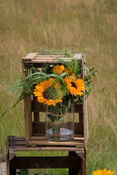 A festive decoration with beautiful yellow sunflowers.