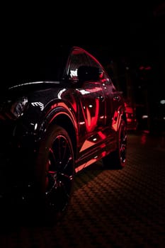 Light reflected in black Audi SUV at night, Boch, Germany