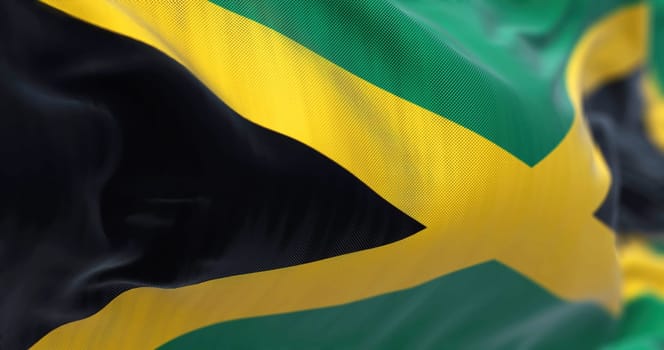 Close-up view of the Jamaica national flag waving in the wind. Jamaica is an island country situated in the Caribbean Sea. Fabric textured background. Selective focus