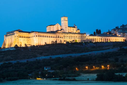 Assisi Basilica by night in Umbria region, Italy. The town is famous for the most important Italian St. Francis Basilica (Basilica di San Francesco)