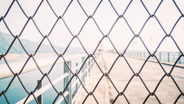 Chainlink fence. Wire fence. Metal net. Wire mesh. Metal grater grille background.