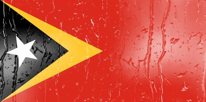 3D Flag of East Timor on a glass with water drop background.