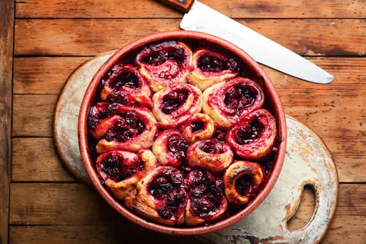 Fresh cottage cheese pie with cherry on rustic wooden table
