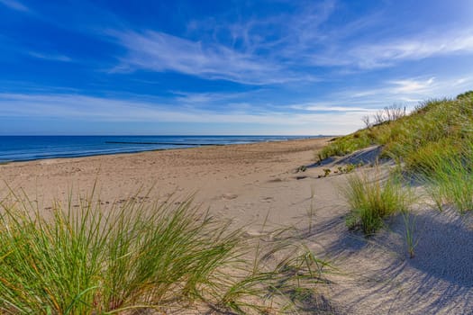 dreamlike, empty baltic sea beach on the island Usedom near Zinnowitz with blue sky