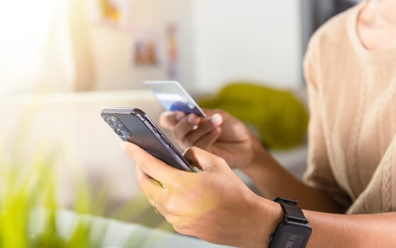 Woman hands holding credit card and smartphone with product purchase at home, Female register via credit cards on mobile phone to make digital payment security online, Internet online shopping concept