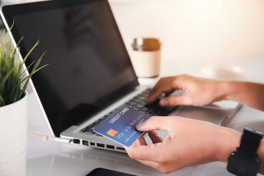 Female register via credit cards on computer make electronic payment security online, Woman hands holding credit card and using laptop with product purchase at home, Internet online shopping concept