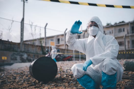 Scientist or Biologist in a protective suit and protect mask collects sample of waste water from industrial for analyze, problem environment, Ecologist sampling water from the river with test tube