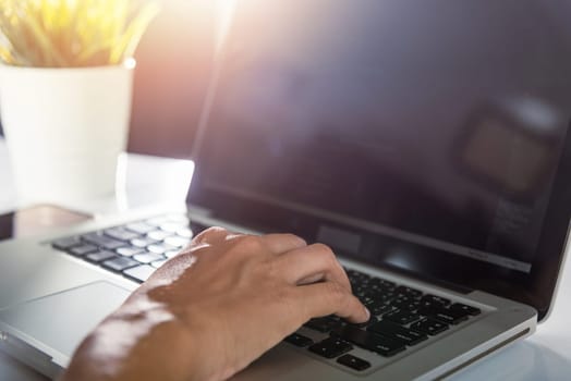 Web application development. programmer woman writing program code sitting at workplace in office, software developer hands coding HTML programming with laptop computer, IT start up concept, back view