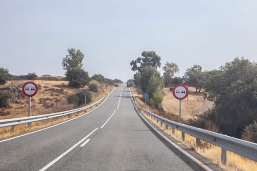 Signs indicating the prohibition of overtaking. Local road with constant grade changes