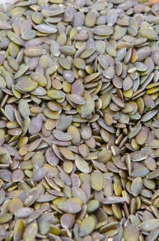 Whole dried pumpkin green seeds. Displayed at street market stall