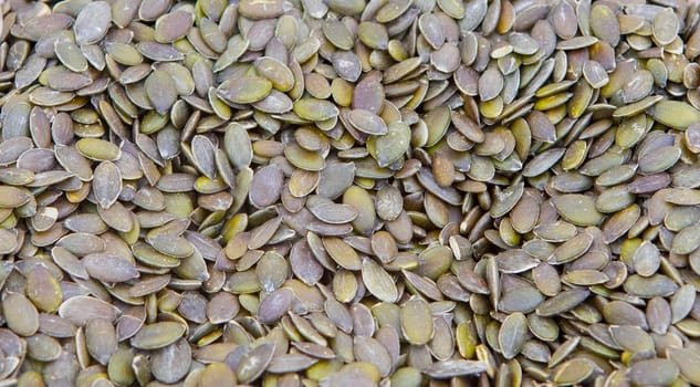 Whole dried pumpkin green seeds. Displayed at street market stall