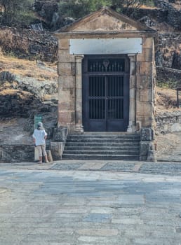 Woman visiting Alcantara bridge temple. Constructed as an offering to Trajan and the gods of Rome. Caceres, Extremadura, Spain