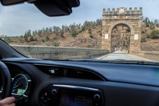 Crossing roman bridge of Alcantara which is still in use from II century B.C. View from the inside of the car