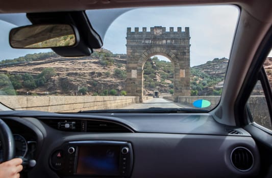 Crossing roman bridge of Alcantara which is still in use from II century B.C. View from the inside of the car