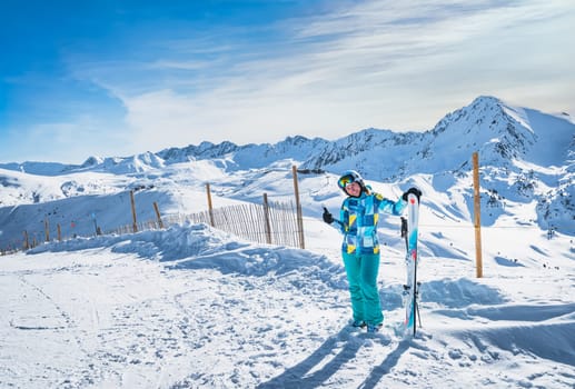 Portrait of a woman skier showing OK sign on the top of the snowy Pyrenees Mountains. Winter ski holidays in El Tarter, Grandvalira, Andorra