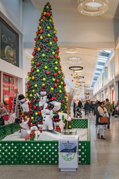Dublin, November 2019 Christmas tree, snowman and decorations in Ilac Shopping Centre. People, families doing Christmas shopping