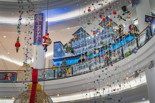 Dublin, November 2019 Santa Claus climbing on a rope, Christmas balls snowman and decorations in Jervis Shopping Centre. Santa grotto or winter castle